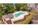 Aerial view of a gated community pool with a bath house and lounge area surrounded by lush trees at 1100 Possum Trot Rd. # C-203, North Myrtle Beach, SC 29582