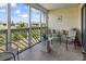 View of screened-in porch with tiled floor, seating and exterior views at 1100 Possum Trot Rd. # C-203, North Myrtle Beach, SC 29582