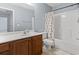 Bathroom with neutral paint, wooden cabinet, and a shower-tub combo at 1102 Stanton Pl. # 1102, Myrtle Beach, SC 29579