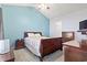 Cozy bedroom features high ceilings, a ceiling fan and warm-toned wood furniture at 1102 Stanton Pl. # 1102, Myrtle Beach, SC 29579