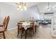 Inviting dining room with a vaulted ceiling, chandelier, hardwood floors, and natural light at 1102 Stanton Pl. # 1102, Myrtle Beach, SC 29579