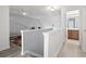 Upstairs hallway with gray walls and hardwood floors leads to the bathroom at 1102 Stanton Pl. # 1102, Myrtle Beach, SC 29579