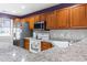 Well-maintained kitchen features stainless steel appliances, stone countertops, and wood cabinetry at 1102 Stanton Pl. # 1102, Myrtle Beach, SC 29579
