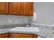 Kitchen area featuring granite counters, wooden cabinetry, and a stainless-steel faucet at 1102 Stanton Pl. # 1102, Myrtle Beach, SC 29579