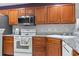 Well-equipped kitchen with stainless steel appliances, wooden cabinets, and granite countertops at 1102 Stanton Pl. # 1102, Myrtle Beach, SC 29579