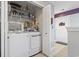 Bright laundry room features a modern washer and dryer, wire shelving, and ample storage space at 1102 Stanton Pl. # 1102, Myrtle Beach, SC 29579