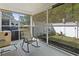 Relaxing screened-in porch with a view of the landscaped backyard and mature trees at 1102 Stanton Pl. # 1102, Myrtle Beach, SC 29579