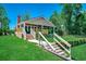 Backyard view of a charming home featuring a deck, covered porch, and landscaped lawn at 112 Blue Gull Dr., Conway, SC 29526
