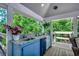 Covered outdoor bar area with granite countertop, sink, and mini fridge, ideal for entertaining at 112 Blue Gull Dr., Conway, SC 29526