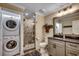 Well-lit bathroom with a walk-in shower, modern vanity, and convenient stackable washer and dryer at 112 Blue Gull Dr., Conway, SC 29526