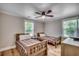 Comfortable bedroom with two twin beds, hardwood floors, and natural light from two windows at 112 Blue Gull Dr., Conway, SC 29526