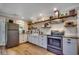 Eat-in kitchen featuring white cabinets, stainless steel appliances, butcher block countertops, and rustic open shelving at 112 Blue Gull Dr., Conway, SC 29526