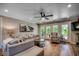 Cozy living room with neutral furnishings, hardwood floors, and access to the outdoor deck at 112 Blue Gull Dr., Conway, SC 29526