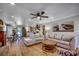 Spacious living room featuring hardwood floors and seamlessly connected to a kitchen and dining area at 112 Blue Gull Dr., Conway, SC 29526