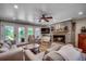 Inviting living room with brick fireplace and neutral-toned furniture overlooking an outdoor deck at 112 Blue Gull Dr., Conway, SC 29526
