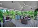 Well-furnished covered patio with a bar, comfortable seating, and serene backyard views at 112 Blue Gull Dr., Conway, SC 29526