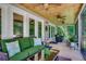Inviting screened porch with comfortable seating, ceiling fans, and a beautiful wood ceiling at 112 Blue Gull Dr., Conway, SC 29526