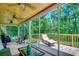 Relaxing screened porch with cozy lounge chair and views of the lush backyard at 112 Blue Gull Dr., Conway, SC 29526