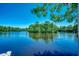 Waterfront view with a serene lake reflecting the sky and surrounding trees, ideal for relaxation at 112 Blue Gull Dr., Conway, SC 29526