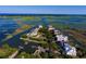 Aerial view of waterfront homes on a scenic island with lush green foliage and docks at 113 Trotter Trail, Georgetown, SC 29440
