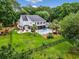Expansive backyard featuring a pool, patio, and lush lawn enclosed by a black fence, perfect for outdoor living at 113 Trotter Trail, Georgetown, SC 29440