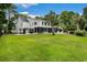 Expansive backyard featuring a well-maintained lawn, a swimming pool, and beautiful landscaping at 113 Trotter Trail, Georgetown, SC 29440
