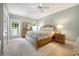 Bright bedroom with a ceiling fan, bedside table, and a large window offering natural light at 113 Trotter Trail, Georgetown, SC 29440