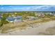 Aerial view of a coastal community featuring a waterfront restaurant and access to the beach at 113 Trotter Trail, Georgetown, SC 29440