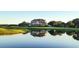 Elegant home overlooking a golf course reflected in a serene pond at 113 Trotter Trail, Georgetown, SC 29440