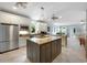 Bright kitchen with stainless steel appliances, a central island, and ample counter space, perfect for culinary enthusiasts at 113 Trotter Trail, Georgetown, SC 29440