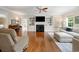 Cozy living room with hardwood floors, a fireplace, built-in shelves, and neutral-toned furnishings for comfortable living at 113 Trotter Trail, Georgetown, SC 29440