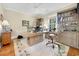 Office with a large desk, wood floors, custom cabinets, and a chair set on top of a floral rug at 113 Trotter Trail, Georgetown, SC 29440