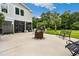 Spacious outdoor patio area with an outdoor kitchen and fire pit, ideal for entertaining guests at 113 Trotter Trail, Georgetown, SC 29440