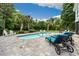 Inviting backyard pool area with stone patio, lounge chairs and manicured landscaping, perfect for relaxing and entertaining at 113 Trotter Trail, Georgetown, SC 29440