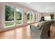 Inviting sunroom with hardwood floors, large windows showcasing backyard greenery, and comfortable seating for relaxation at 113 Trotter Trail, Georgetown, SC 29440
