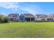 Spacious backyard with green lawn and view of rear house exteriors at 1131 East Isle Of Palms, Myrtle Beach, SC 29579