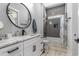 This bathroom features gray tile walls, marble countertops, and modern fixtures and lighting at 1131 East Isle Of Palms, Myrtle Beach, SC 29579