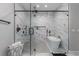 Modern bathroom with a glass-enclosed shower, soaking tub, and marble tile at 1131 East Isle Of Palms, Myrtle Beach, SC 29579