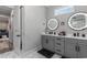 Bathroom featuring double sink vanity, tile floors and modern light fixtures at 1131 East Isle Of Palms, Myrtle Beach, SC 29579