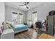 This bedroom features wood-look floors, two windows, a ceiling fan, and plenty of natural light at 1131 East Isle Of Palms, Myrtle Beach, SC 29579