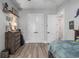 Bedroom with wood-look floors, a ceiling fan, and double door closet with white doors at 1131 East Isle Of Palms, Myrtle Beach, SC 29579