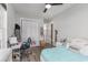 Bright bedroom featuring wood-look floors, a ceiling fan, white trim and a desk area at 1131 East Isle Of Palms, Myrtle Beach, SC 29579