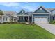 Charming blue two-story home with a well-manicured lawn and an attached two-car garage at 1131 East Isle Of Palms, Myrtle Beach, SC 29579