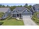 Charming blue two-story home with a well-manicured lawn and an attached two-car garage at 1131 East Isle Of Palms, Myrtle Beach, SC 29579