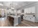 Bright kitchen with white cabinets, granite countertops, stainless steel appliances, and an island with seating at 1131 East Isle Of Palms, Myrtle Beach, SC 29579