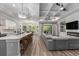 Open-concept living space with island seating, a coffered ceiling, fireplace, and hardwood flooring at 1131 East Isle Of Palms, Myrtle Beach, SC 29579