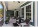 Charming covered outdoor patio with comfortable seating and a ceiling fan at 1131 East Isle Of Palms, Myrtle Beach, SC 29579