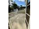 The back deck is accessible through a screen door and features a white railing at 118 Retreat Pl., Little River, SC 29566