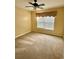 Cozy carpeted bedroom featuring a ceiling fan and a window with blinds at 118 Retreat Pl., Little River, SC 29566