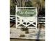 Entrance to The Retreat, a POA community, framed by lush landscaping and a welcoming white fence at 118 Retreat Pl., Little River, SC 29566